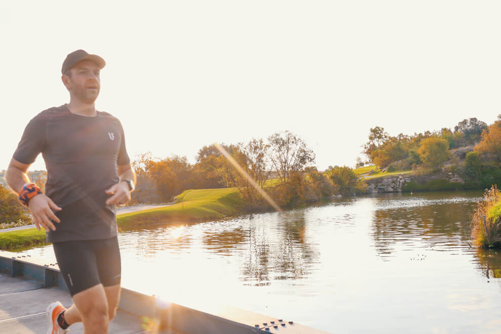 Man running along a dam